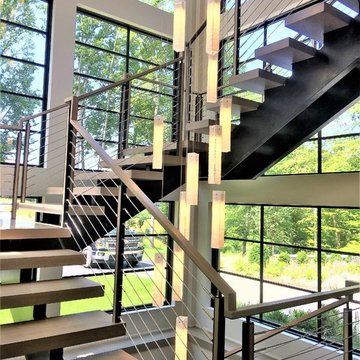 Vaddi - floating double steel center stringer with cable railing