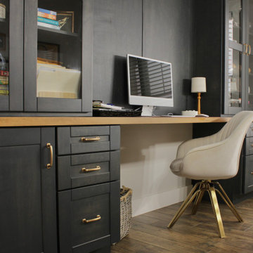 Home office with clean cabinetry, integrated storage, and a functional layout