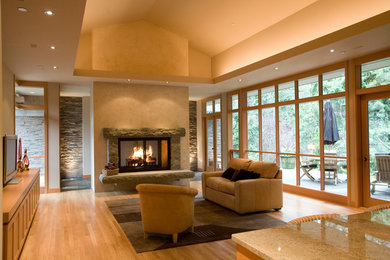 Design ideas for a large contemporary open concept living room in Seattle with beige walls, light hardwood floors, a two-sided fireplace, a stone fireplace surround and no tv.
