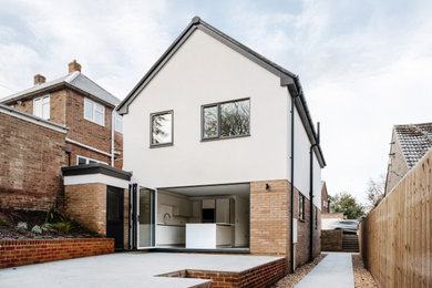 Inspiration for a white contemporary two floor render and rear detached house in Gloucestershire with a pitched roof, a tiled roof and a black roof.
