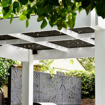 Cut-Out Trellises Top the Pergola & Give Privacy at Outdoor Kitchen
