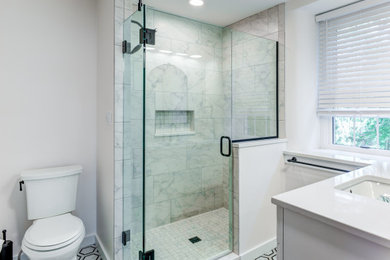 Example of a cottage multicolored tile and ceramic tile marble floor, multicolored floor and single-sink alcove shower design in Other with shaker cabinets, white cabinets, a two-piece toilet, white walls, a drop-in sink, quartz countertops, a hinged shower door, white countertops and a freestanding vanity