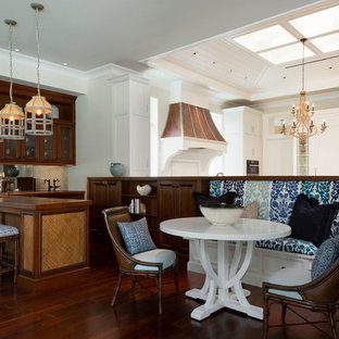 Inspiration for a mid-sized tropical open plan dining in Miami with white walls, medium hardwood floors and brown floor.