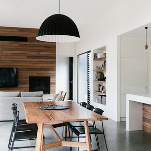 ジーロングの中サイズのコンテンポラリースタイルのLDKの画像 (白い壁、コンクリートの床)