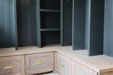 Mid-sized transitional porcelain tile mudroom photo in Detroit with white walls