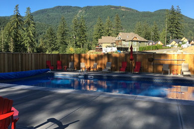 Design ideas for a mid-sized rustic partial sun and privacy backyard concrete paver and wood fence landscaping in Vancouver for summer.