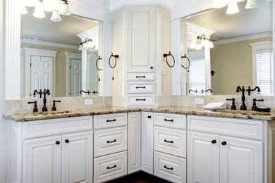 Photo of a large traditional master bathroom in Other with an undermount sink, raised-panel cabinets, white cabinets, granite benchtops and beige walls.