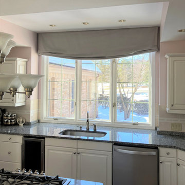 Soft roman valance with motorized roller shade in kitchen
