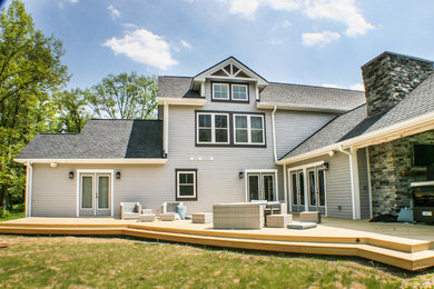 Photo of a large traditional two-storey grey house exterior in Cincinnati with mixed siding.