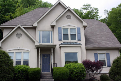This is an example of a large two-storey stucco beige exterior in Nashville.