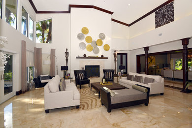 Example of a large trendy formal and open concept marble floor and beige floor living room design in Miami with white walls, a standard fireplace, a stone fireplace and no tv
