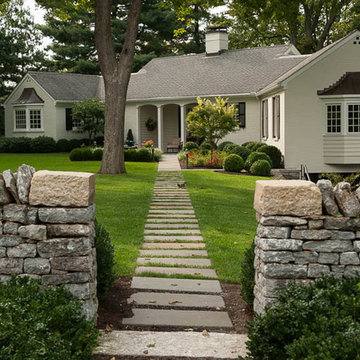 Bluestone step stone path pierces limestone wall and  transitions to solid blues