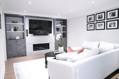 Inspiration for a mid-sized contemporary family room remodel in Toronto with a media wall