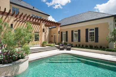 Photo of a traditional backyard rectangular pool in Houston.