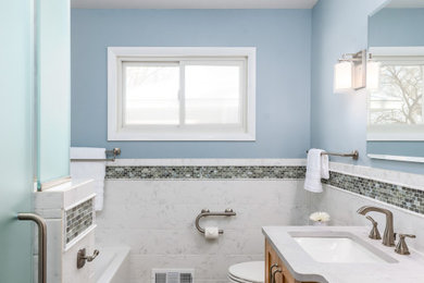 Inspiration for a mid-sized white tile and porcelain tile porcelain tile, single-sink and wainscoting bathroom remodel in Minneapolis with light wood cabinets, a one-piece toilet, blue walls, a drop-in sink, quartz countertops and a freestanding vanity
