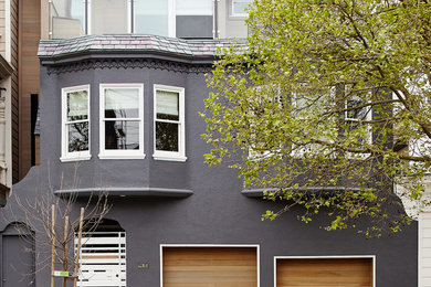Design ideas for a mid-sized eclectic two-storey grey house exterior in San Francisco with mixed siding, a flat roof and a mixed roof.