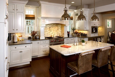 Enclosed kitchen - large transitional l-shaped dark wood floor and brown floor enclosed kitchen idea in Kansas City with a farmhouse sink, recessed-panel cabinets, white cabinets, marble countertops, white backsplash, marble backsplash, stainless steel appliances and an island