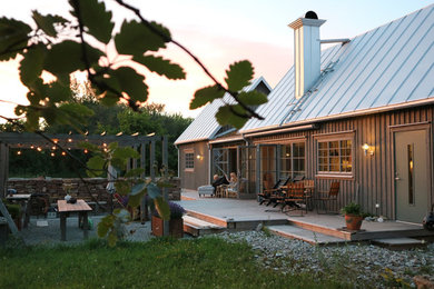 Mountain style black exterior home photo in Other with a metal roof