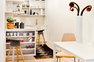 Eat-in kitchen - small modern l-shaped light wood floor eat-in kitchen idea in New York with an undermount sink, open cabinets, paneled appliances, no island, gray cabinets, quartz countertops and metallic backsplash