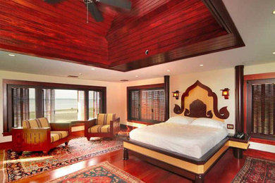Mid-sized eclectic master dark wood floor and brown floor bedroom photo in Other with beige walls and no fireplace