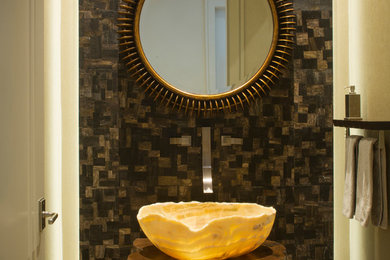 Powder room - small rustic beige tile, brown tile and stone tile travertine floor powder room idea in Miami with furniture-like cabinets, medium tone wood cabinets, beige walls, a vessel sink, wood countertops and brown countertops