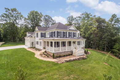 Mid-sized farmhouse white two-story concrete fiberboard house exterior idea in Other with a hip roof and a shingle roof