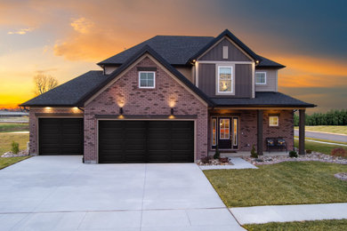 Large modern brown two-story mixed siding and board and batten house exterior idea in Louisville with a hip roof, a shingle roof and a black roof