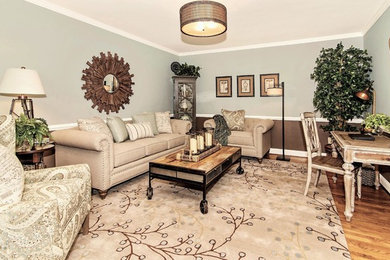 Example of a mid-sized transitional formal and enclosed light wood floor living room design in DC Metro with blue walls, no fireplace and no tv