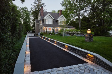 Photo of a large transitional front yard full sun driveway in New York with a garden path and brick pavers.