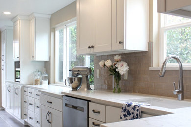 Inspiration for a mid-sized timeless galley vinyl floor and multicolored floor eat-in kitchen remodel in Seattle with an undermount sink, shaker cabinets, white cabinets, quartz countertops, gray backsplash, subway tile backsplash, stainless steel appliances, no island and white countertops