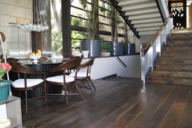Photo of a traditional dining room in Miami with dark hardwood floors.