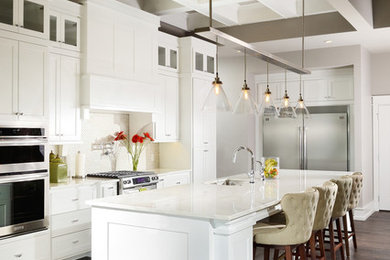 Open concept kitchen - large traditional u-shaped medium tone wood floor open concept kitchen idea in Other with an undermount sink, shaker cabinets, marble countertops, white backsplash, porcelain backsplash, stainless steel appliances, an island and white cabinets