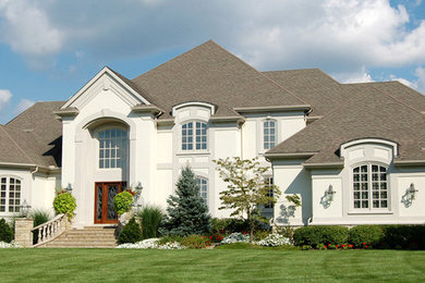 Inspiration for a large timeless beige two-story exterior home remodel in Toronto