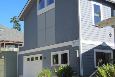 Contemporary gray clapboard gable roof idea in Seattle with a shingle roof