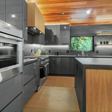 Wall Ovens and Floating Walnut Shelves Beside the Range