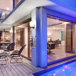 Outdoor view of pool and entertaining area with Breezway Louvres - Windows