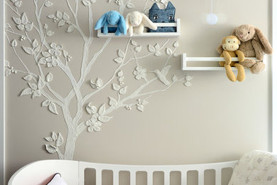 Inspiration for a mid-sized modern gender-neutral dark wood floor nursery remodel in Toronto with beige walls