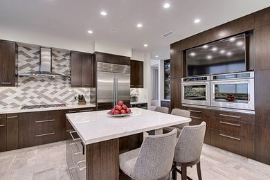 Inspiration for a large contemporary porcelain tile enclosed kitchen remodel in Los Angeles with an undermount sink, flat-panel cabinets, dark wood cabinets, granite countertops, multicolored backsplash, glass tile backsplash, stainless steel appliances and an island