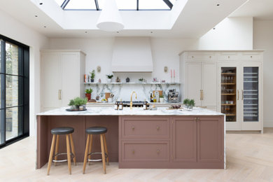 Inspiration for a medium sized traditional single-wall kitchen in London with a submerged sink, shaker cabinets, marble worktops, marble splashback, integrated appliances, light hardwood flooring and an island.