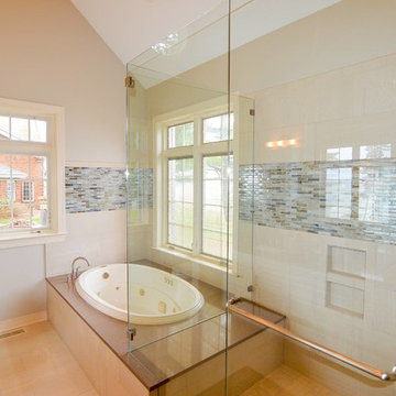 Master bathroom with whirlpool bath and glass-enclosed walk-in shower
