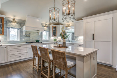 Example of a large french country u-shaped medium tone wood floor and brown floor eat-in kitchen design in Nashville with shaker cabinets, white cabinets, blue backsplash, an island and white countertops