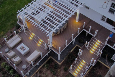Example of a large classic backyard outdoor kitchen deck design in DC Metro with a pergola
