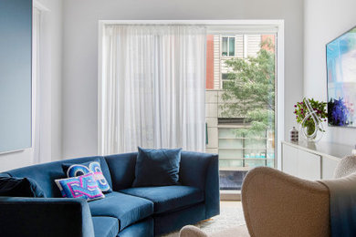 Example of a trendy light wood floor and beige floor living room design in New York with white walls