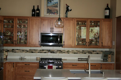 Mid-sized transitional l-shaped dark wood floor, multicolored floor and tray ceiling open concept kitchen photo in San Francisco with a single-bowl sink, glass-front cabinets, medium tone wood cabinets, wood countertops, multicolored backsplash, mosaic tile backsplash, stainless steel appliances, an island and multicolored countertops