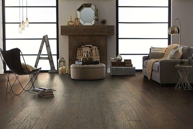 Example of a mid-sized trendy formal and open concept medium tone wood floor and brown floor living room design in Orange County with gray walls, no fireplace and no tv