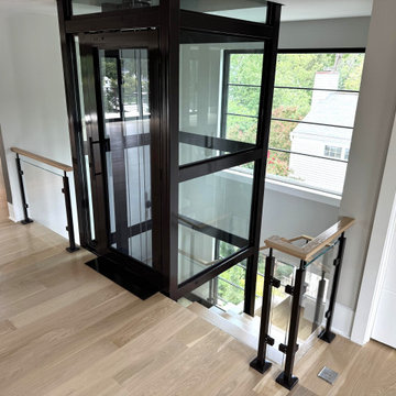 Project #136 | Modern Floating Staircase Encircling Glass Elevator