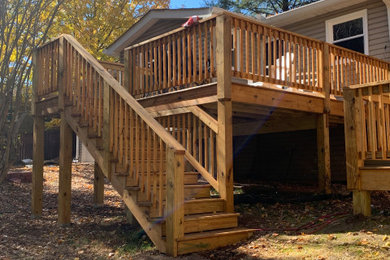 Inspiration for a large backyard ground level wood railing deck remodel in Nashville