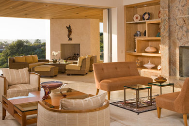 Design ideas for a mid-sized contemporary formal enclosed living room in San Diego with beige walls, limestone floors, a standard fireplace and a stone fireplace surround.
