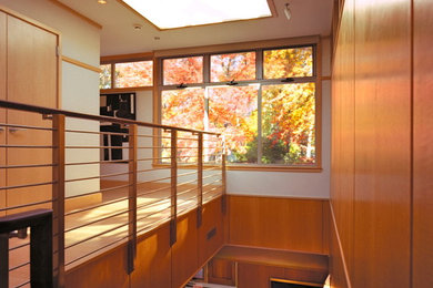 Photo of a mid-sized midcentury wood l-shaped staircase in New York with wood risers.