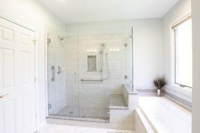 Example of a mid-sized master white tile vinyl floor, white floor and double-sink bathroom design in Cleveland with raised-panel cabinets, white cabinets, a two-piece toilet, gray walls, an undermount sink, granite countertops, a hinged shower door, gray countertops and a built-in vanity